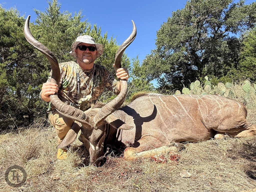 Hunter with a trophy Greater Kudu bull and its spiral horns at Texas Hunt Lodge in Texas